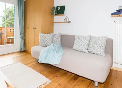 a living room with a couch with pillows at Haus Claudia B&B in Nova Levante