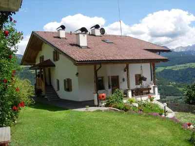 a small white house with a roof on a hill at Malsethhof in Villandro