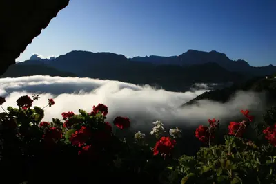 a view of a valley with clouds in the mountains at Malsethhof in Villandro