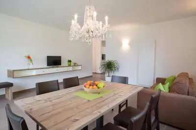 a dining room with a table with a bowl of fruit on it at Ferienwohnungen Hochbrunner in Terlano
