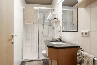 a bathroom with a shower and a sink and a toilet at Apartment Wieser Eppan in Appiano sulla Strada del Vino