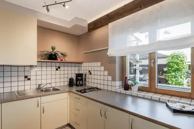 a kitchen with white cabinets and a window at Apartment Wieser Eppan in Appiano sulla Strada del Vino
