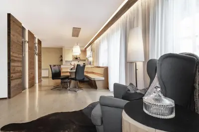 a living room with a couch and a table with chairs at Apartment Wieser Eppan in Appiano sulla Strada del Vino