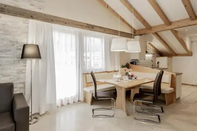 a kitchen and dining room with a table and chairs at Apartment Wieser Eppan in Appiano sulla Strada del Vino