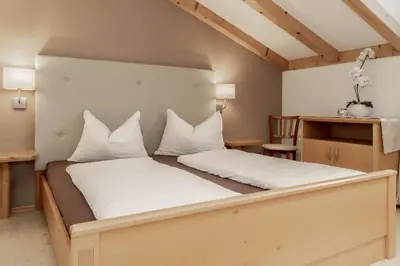 a bedroom with a large bed with white pillows at Apartment Wieser Eppan in Appiano sulla Strada del Vino