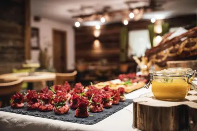 a table with a bunch of food on a table at Lüch de Costa in Colfosco