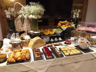 a table with a buffet of different types of food at Lüch de Costa in Colfosco