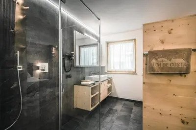 a bathroom with a shower and a sink at Lüch de Costa in Colfosco