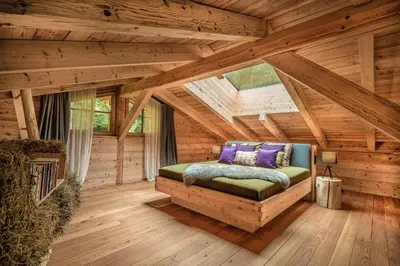 a bedroom in a log cabin with a bed at Valsegg Chalets Südtirol - luxury and private hideaway in Valles