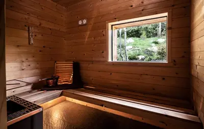 a sauna with a window in a wooden cabin at Valsegg Chalets Südtirol - luxury and private hideaway in Valles