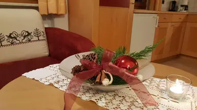 a plate with a christmas ornament on a table at Appartement Huber in Brunico