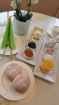 a table with two plates of food on it at Appartement Huber in Brunico