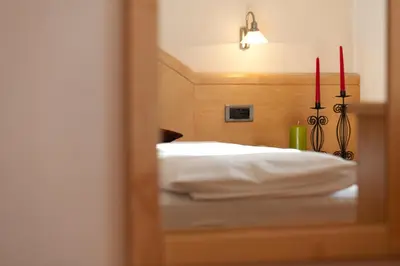 a reflection of a bedroom with a bed in a mirror at Appartement Huber in Brunico