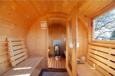 a wooden sauna with a large window in a cabin at Salahaus in Verano
