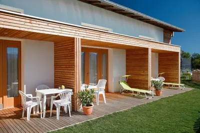 a wooden deck with a table and chairs on a house at Salahaus in Verano