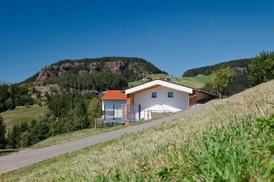 a house on a hill next to a road at Salahaus in Verano
