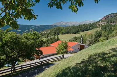 a building with an orange roof on a hill at Salahaus in Verano