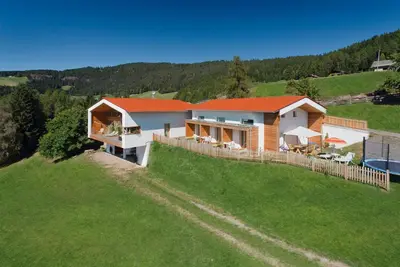 a house on top of a grassy hill at Salahaus in Verano