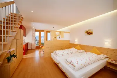 a bedroom with a large bed and a staircase at Salahaus in Verano