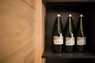 three bottles of wine sitting on a shelf at Landhaus Lina in Caldaro