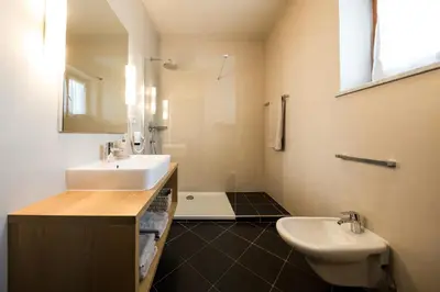 a bathroom with a sink and a toilet at Landhaus Lina in Caldaro