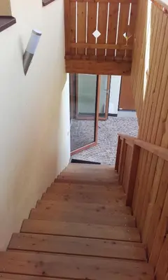 a staircase in a house with wooden floors at Ferienhof Weingenuss in Cortina Sulla Strada Del Vino