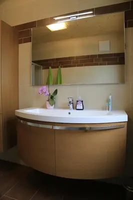 a bathroom with a sink and a mirror at Ferienhof Weingenuss in Cortina Sulla Strada Del Vino