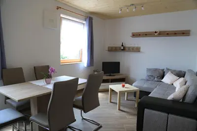 a living room with a table and a couch at Ferienhof Weingenuss in Cortina Sulla Strada Del Vino