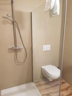 a shower stall with a toilet in a bathroom at Das Sonnenheim in Marlengo
