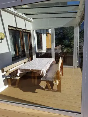 a screened in porch with a bench on a patio at Das Sonnenheim in Marlengo