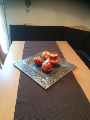 a plate of apples on top of a table at Ciasa Orzun in San Vigilio Di Marebbe
