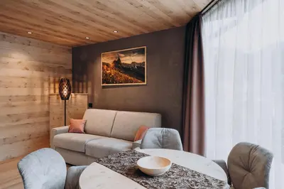 a living room with a couch and a table at B&B Aretia in Santa Cristina in Val Gardena