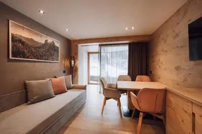 a living room with a couch and a table at B&B Aretia in Santa Cristina in Val Gardena