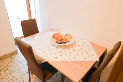 a table with a plate of food on top of it at COL DE RIF Appartamento Storico nelle Dolomiti in Falcade