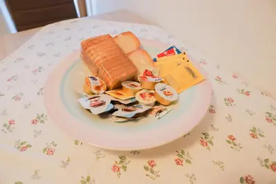 a plate of food on a table with a sandwich at COL DE RIF Appartamento Storico nelle Dolomiti in Falcade