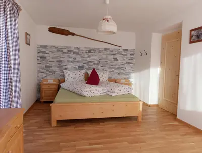 a bedroom with a bed with red pillows on it at Niederhof in Parcines