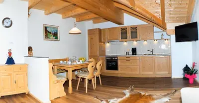 a kitchen with a wooden table and a kitchen with a kitchen at Niederhof in Parcines