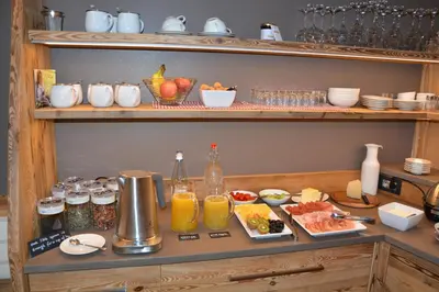 a shelf with food and drinks on it at DOLOMITES B&B - Suites, Apartments and SPA in Tesero