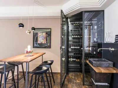 a bar with a table and chairs and a wine cellar at Apartment Rametz by Interhome in Postal