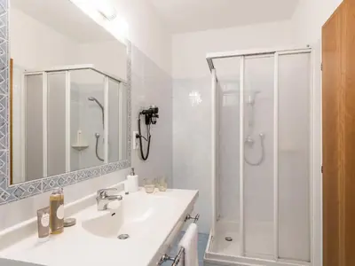 a white bathroom with a sink and a shower at Apartment Rametz by Interhome in Postal