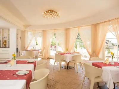 a restaurant with tables and chairs and a chandelier at Apartment Schöneck by Interhome in Postal