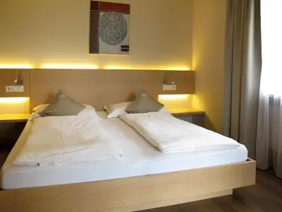 a bedroom with a bed with white sheets and pillows at Apartment Schöneck by Interhome in Postal
