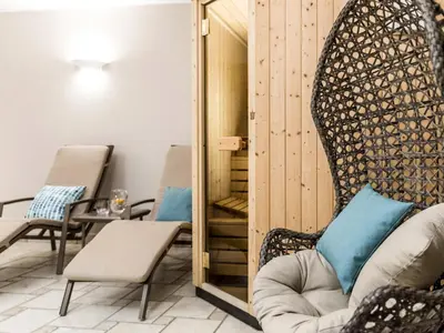 a living room with a chair and a table at Apartment Boymont by Interhome in Postal