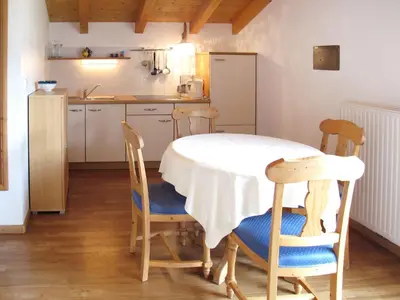 a kitchen with a table and chairs in a kitchen at Apartment Boymont by Interhome in Postal