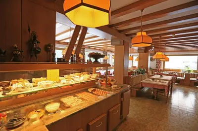 a buffet line in a restaurant with a lot of food at Appartamenti Arnica in Alba di Canazei