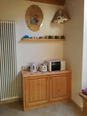 a kitchen with a microwave on a counter at B&B El Molin in Cavalese