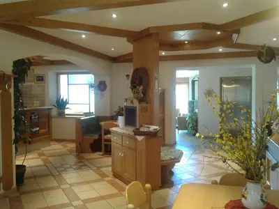 a living room with a kitchen and a dining room at Albergo Pensione Serenetta in Varena