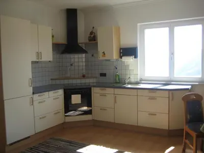 a kitchen with white cabinets and a sink and a window at Haus Gilli in Lagundo