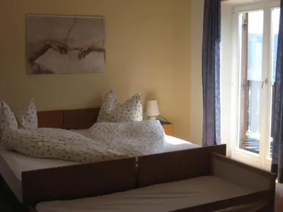 a bedroom with a bed with pillows and a window at Haus Gilli in Lagundo