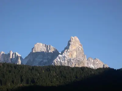 a mountain range with trees in the foreground at Casa Angela in Predazzo